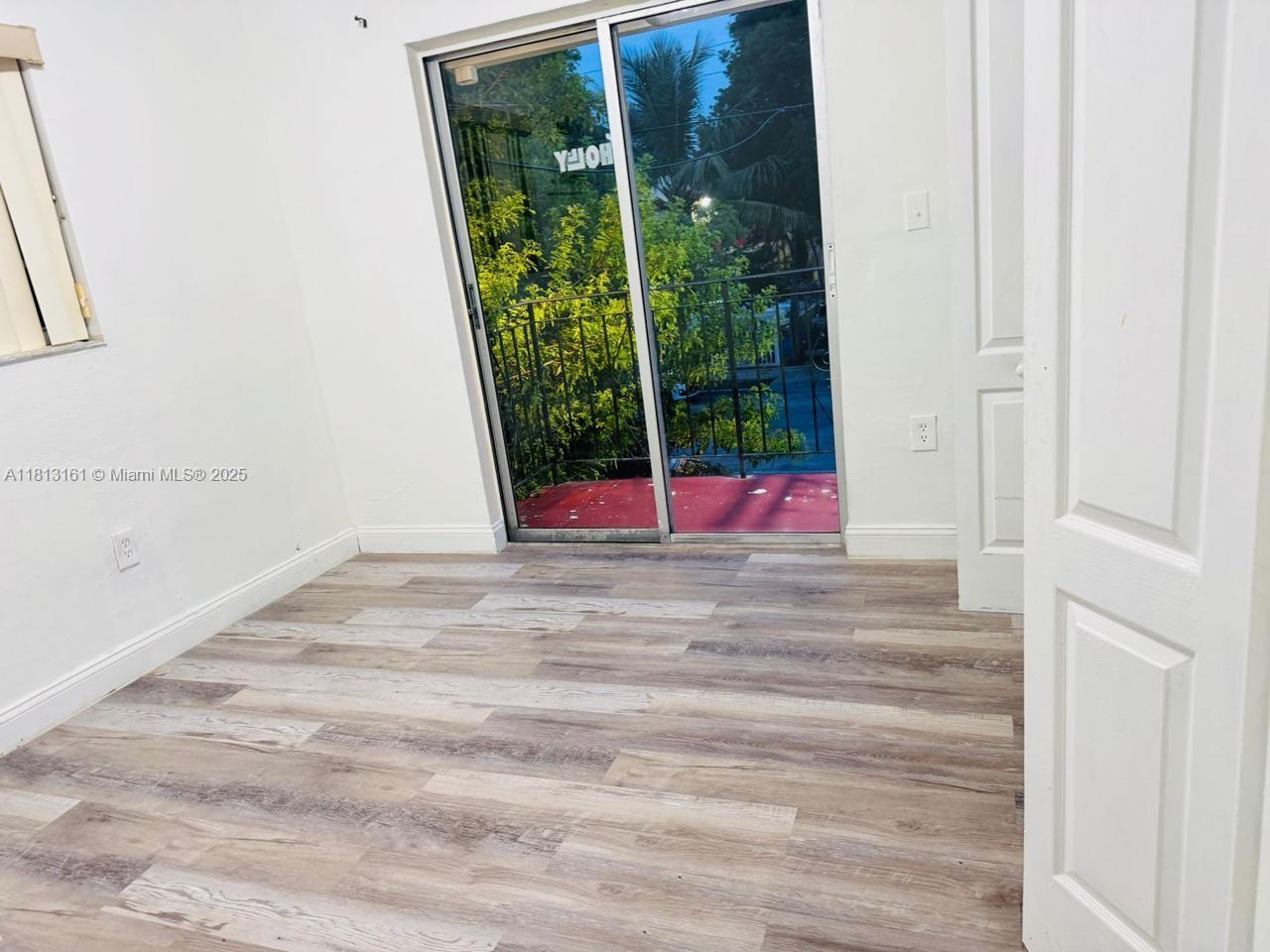 932 Northwest 5th Street, Unit 4 Miami, FL 33128 - Photo 3 of 16 a view of empty room with floor to ceiling window