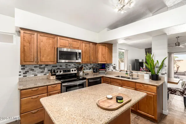 a kitchen with a stove a sink and a refrigerator