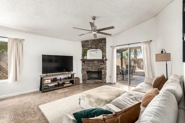 a living room with furniture a fireplace and a flat screen tv