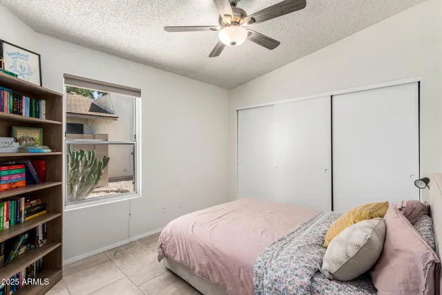 a bedroom with a bed and a book shelf