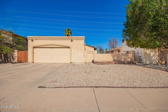 a view of garage and wooden fence