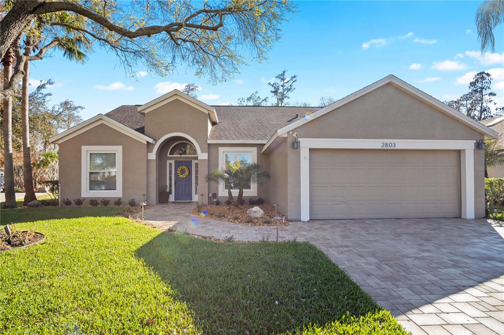 2803 Runyon Circle Orlando, FL 32837 - Photo 1 of 1 a front view of a house with a garden and yard