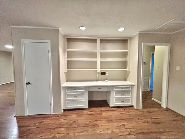 a view of an empty room with a fireplace and a window