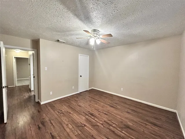 a view of an empty room and wooden floor
