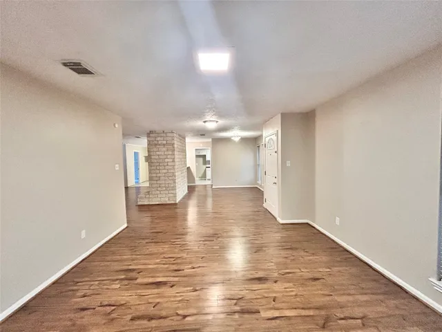 a view of interior space with wooden floor and windows