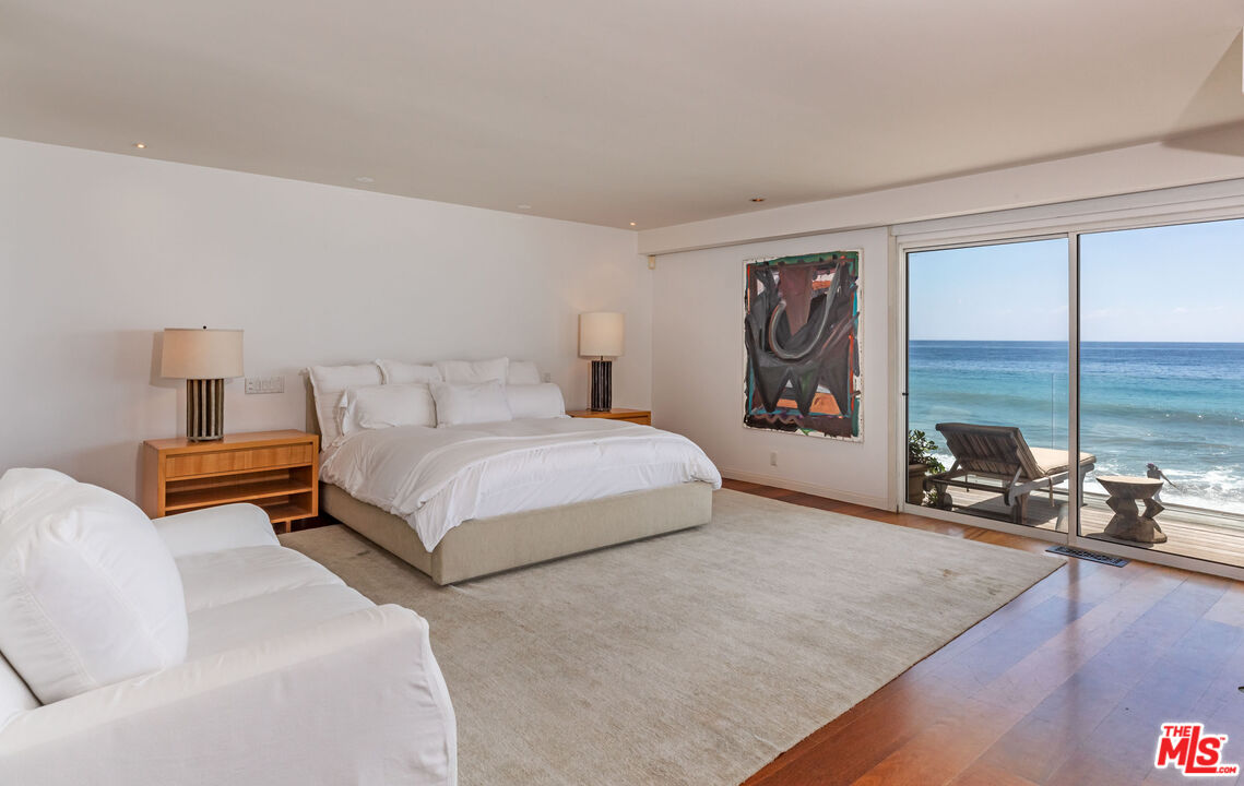 22148 Pacific Coast Highway Malibu, CA 90265 - Photo 15 of 28 a bedroom with a large bed and a large window