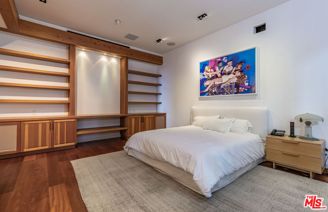 22148 Pacific Coast Highway Malibu, CA 90265 - Photo 24 of 28 a bedroom with a bed and a book shelf