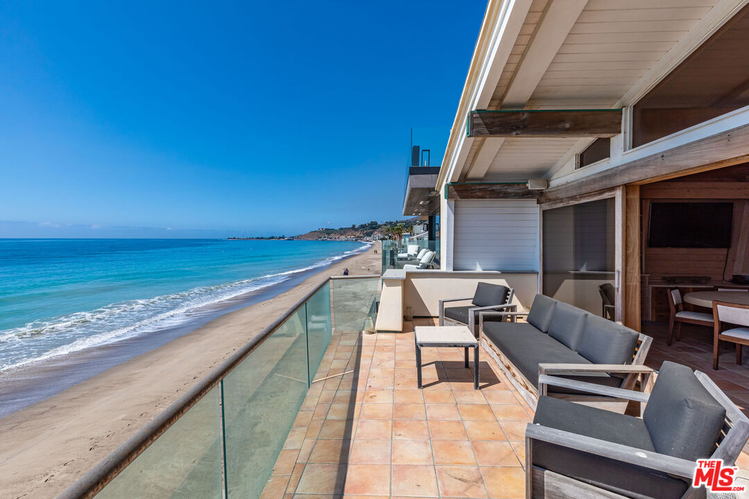 22148 Pacific Coast Highway Malibu, CA 90265 - Photo 28 of 28 a terrace with outdoor seating and ocean view