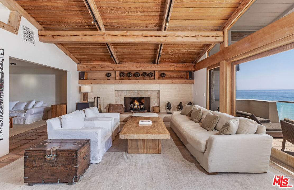 22148 Pacific Coast Highway Malibu, CA 90265 - Photo 7 of 28 a living room with furniture and a fireplace