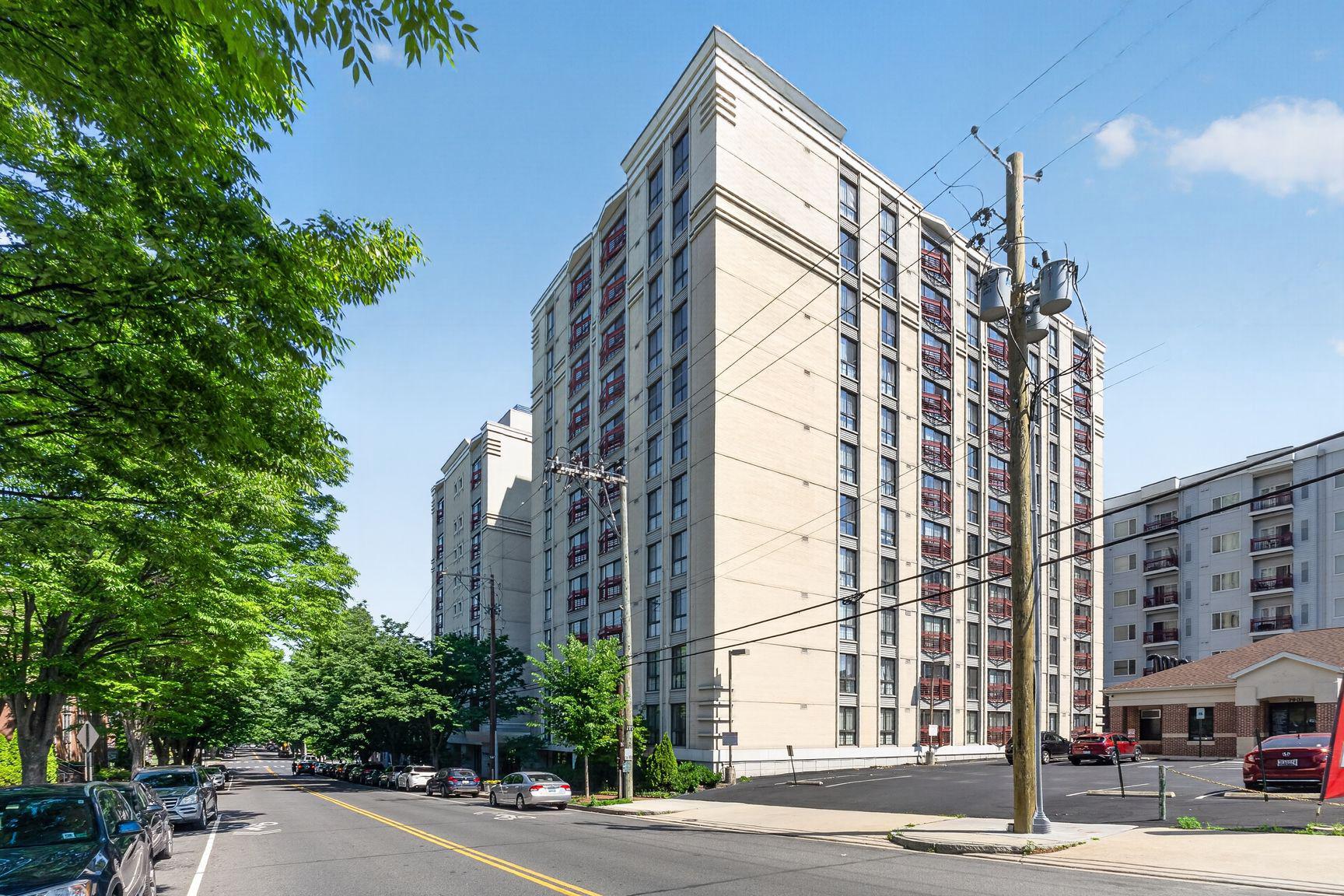 7915 Eastern Avenue Northwest, Unit 1011 Silver Spring, MD 20910 - Photo 2 of 28 a city street lined with buildings and trees