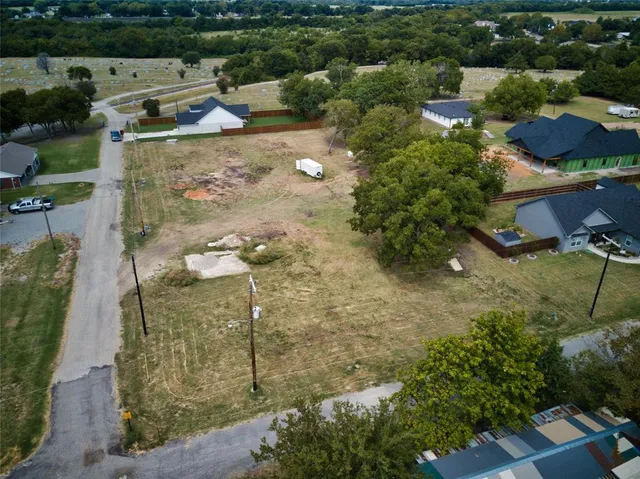 an aerial view of a house with a yard