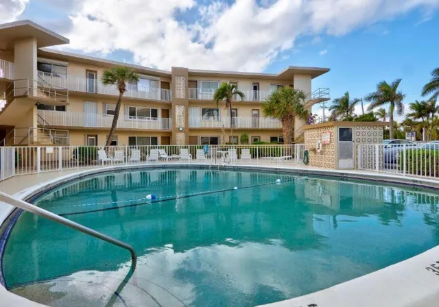 a swimming pool view with a outdoor seating