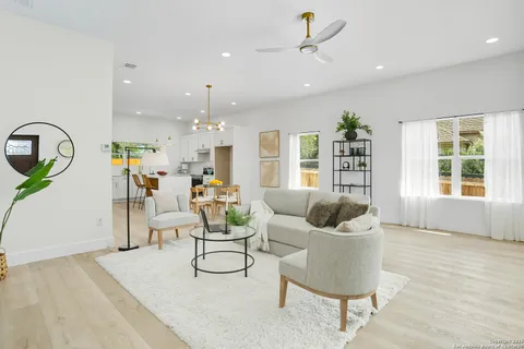a living room with furniture and wooden floor