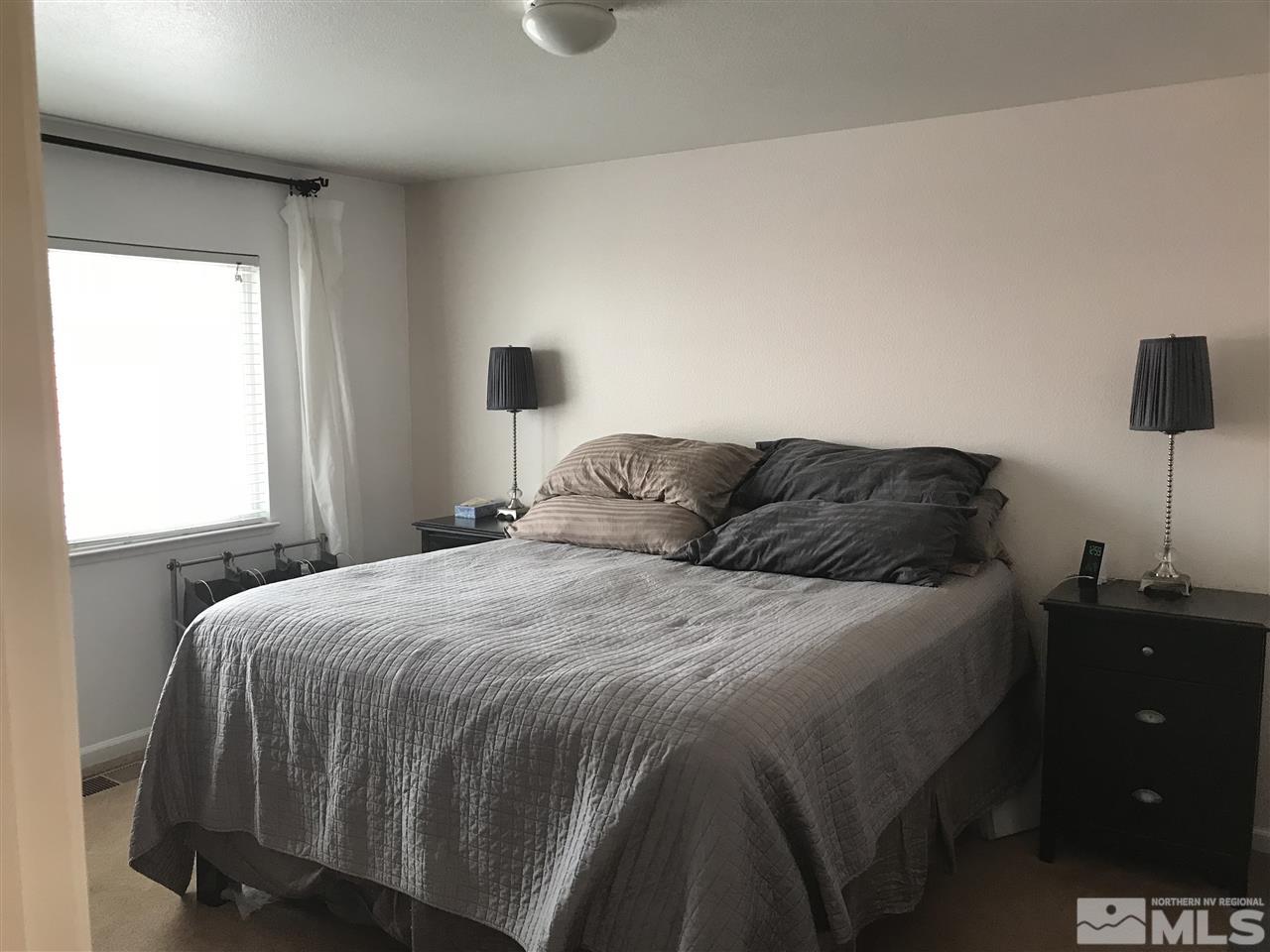 17891 Brushland Drive Reno, NV 89508 - Photo 16 of 25 a bedroom with a bed and a night stand