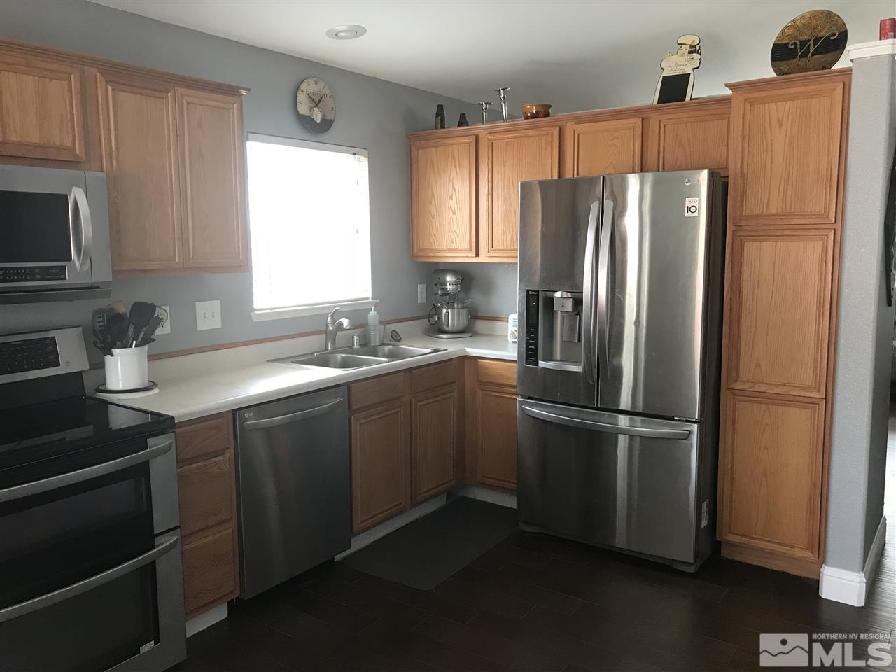 17891 Brushland Drive Reno, NV 89508 - Photo 7 of 25 a kitchen with stainless steel appliances a refrigerator stove microwave and sink