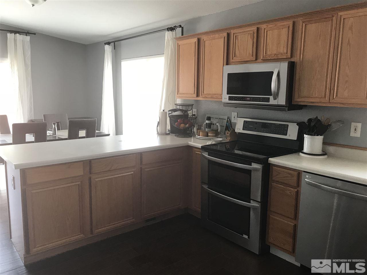 17891 Brushland Drive Reno, NV 89508 - Photo 8 of 25 a kitchen with a sink stove and microwave