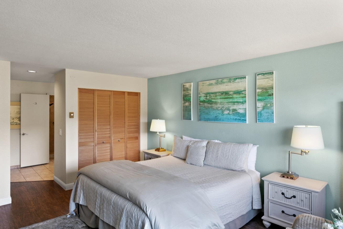 4 Shepherds Knoll Road Monterey, CA 93940 - Photo 19 of 28 a bedroom with a bed and wooden floor