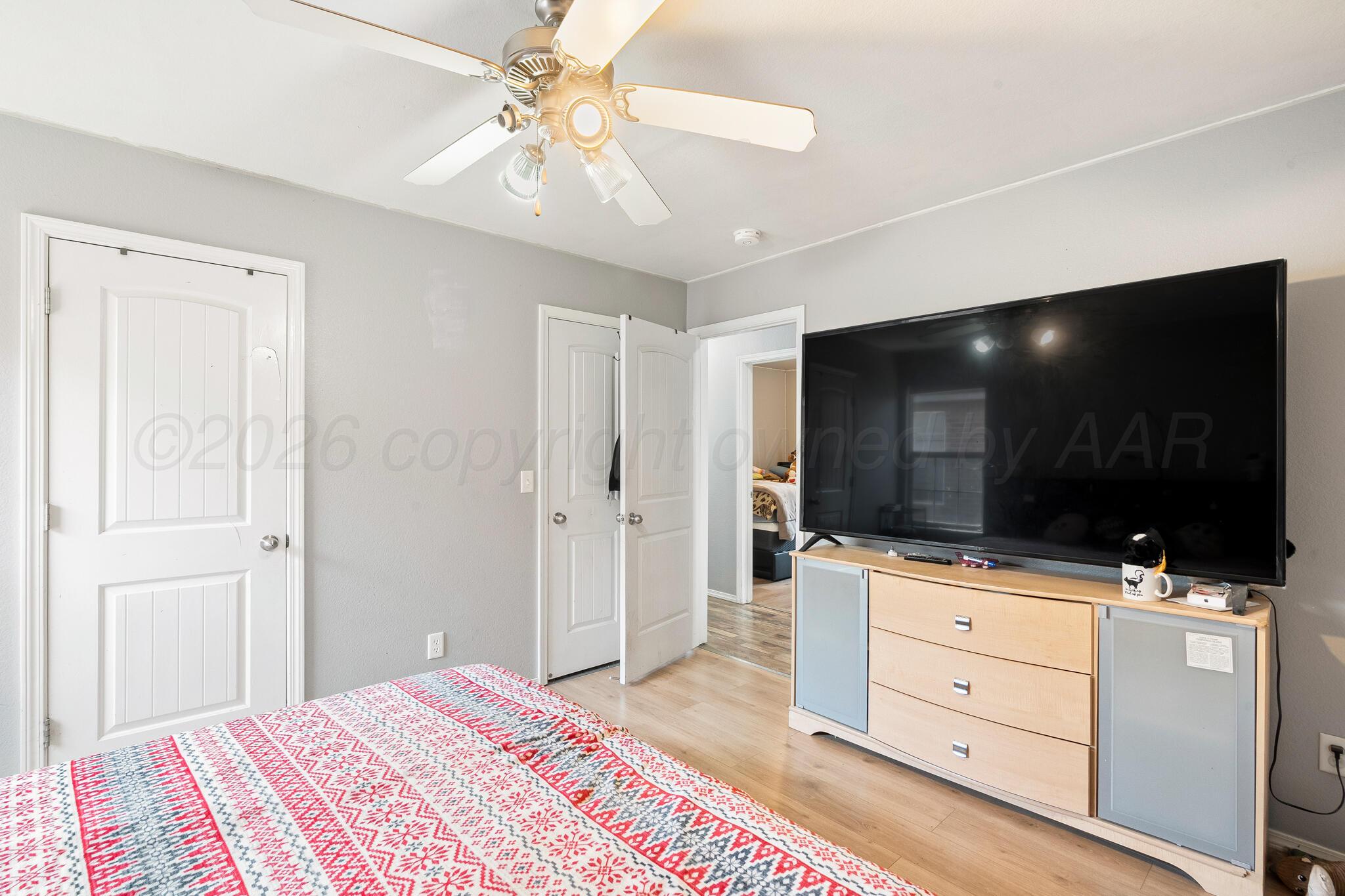 1921 South Fairfield Street Amarillo, TX 79103 - Photo 13 of 18 a bedroom with a bed and a flat screen tv