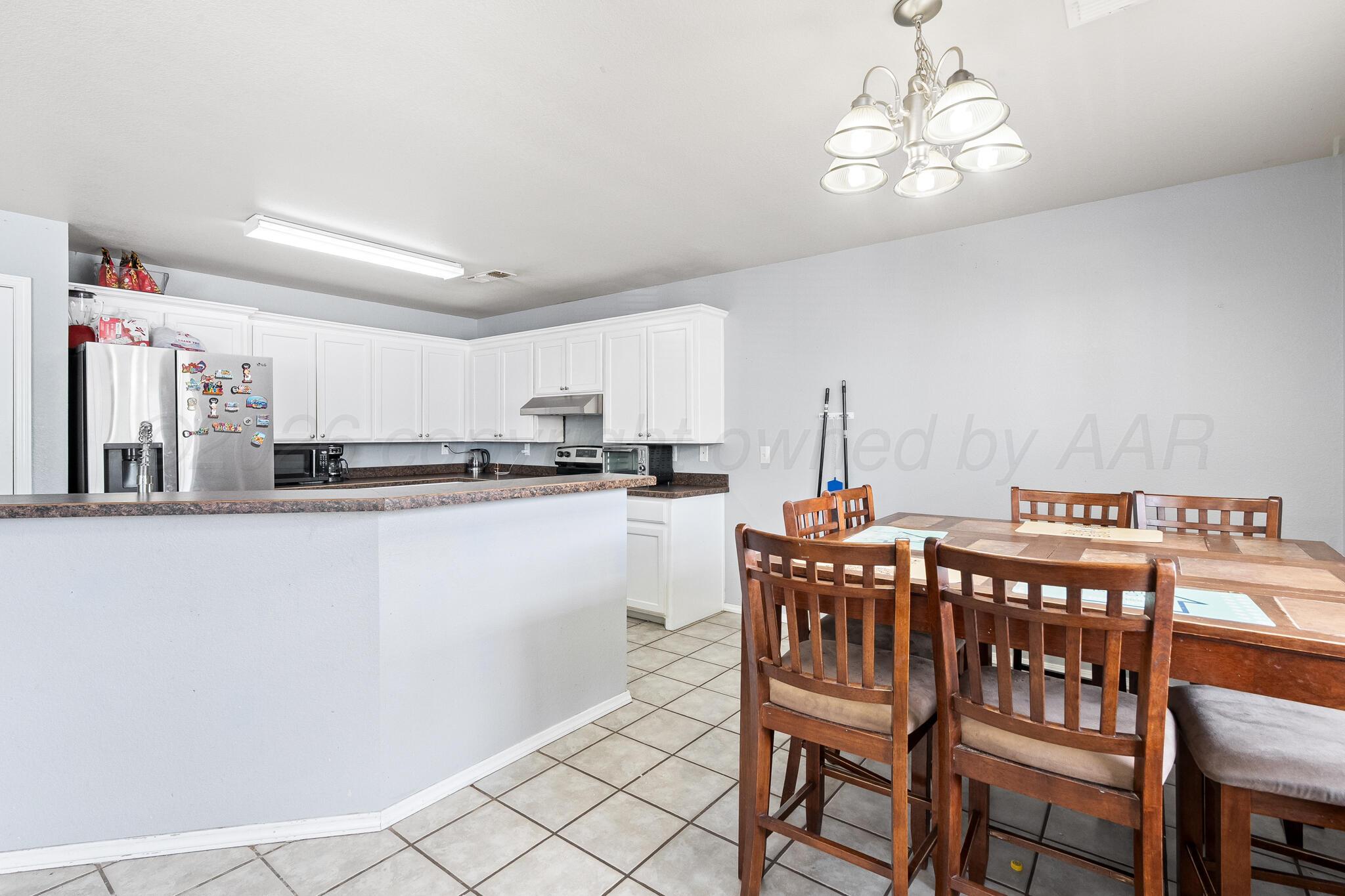1921 South Fairfield Street Amarillo, TX 79103 - Photo 5 of 18 a dining room with furniture a chandelier and window