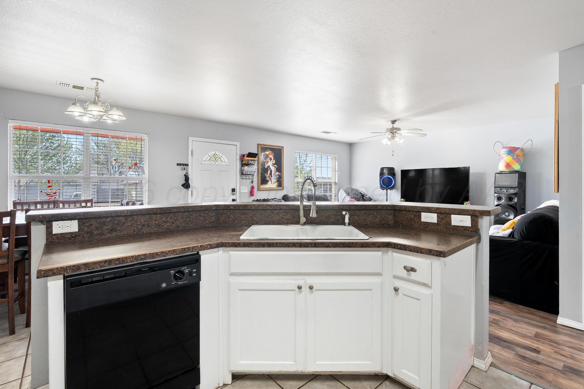 1921 South Fairfield Street Amarillo, TX 79103 - Photo 6 of 18 a kitchen with stainless steel appliances granite countertop a sink and cabinets