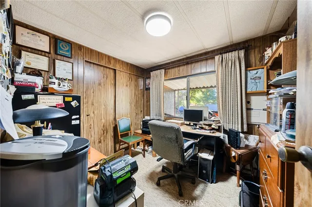 a view of a workspace with furniture and a window