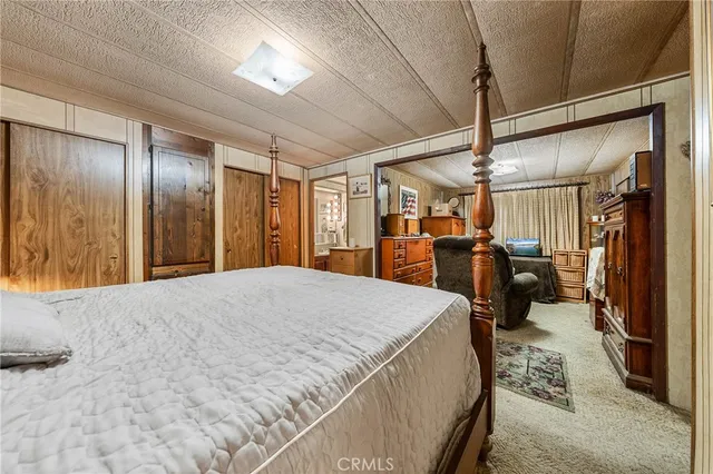 a bed room with a bed and a large mirror