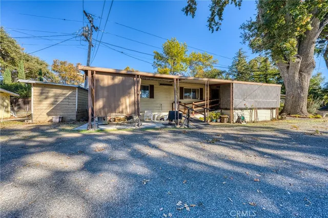 a view of a backyard with a table under an umbrella
