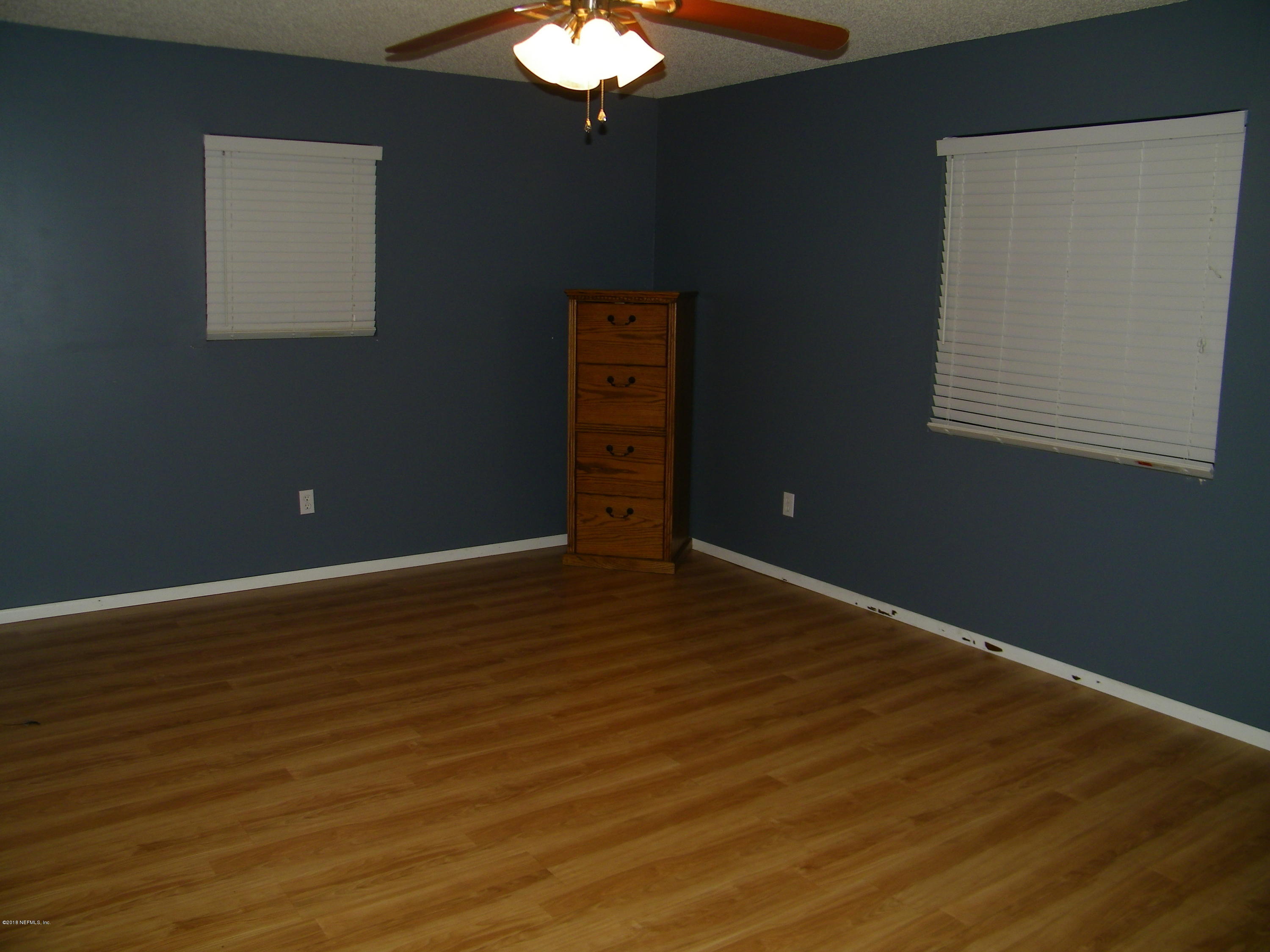 13296 Yellow Bluff Road Jacksonville, FL 32226 - Photo 8 of 13 a view of a livingroom with wooden floor and a ceiling fan