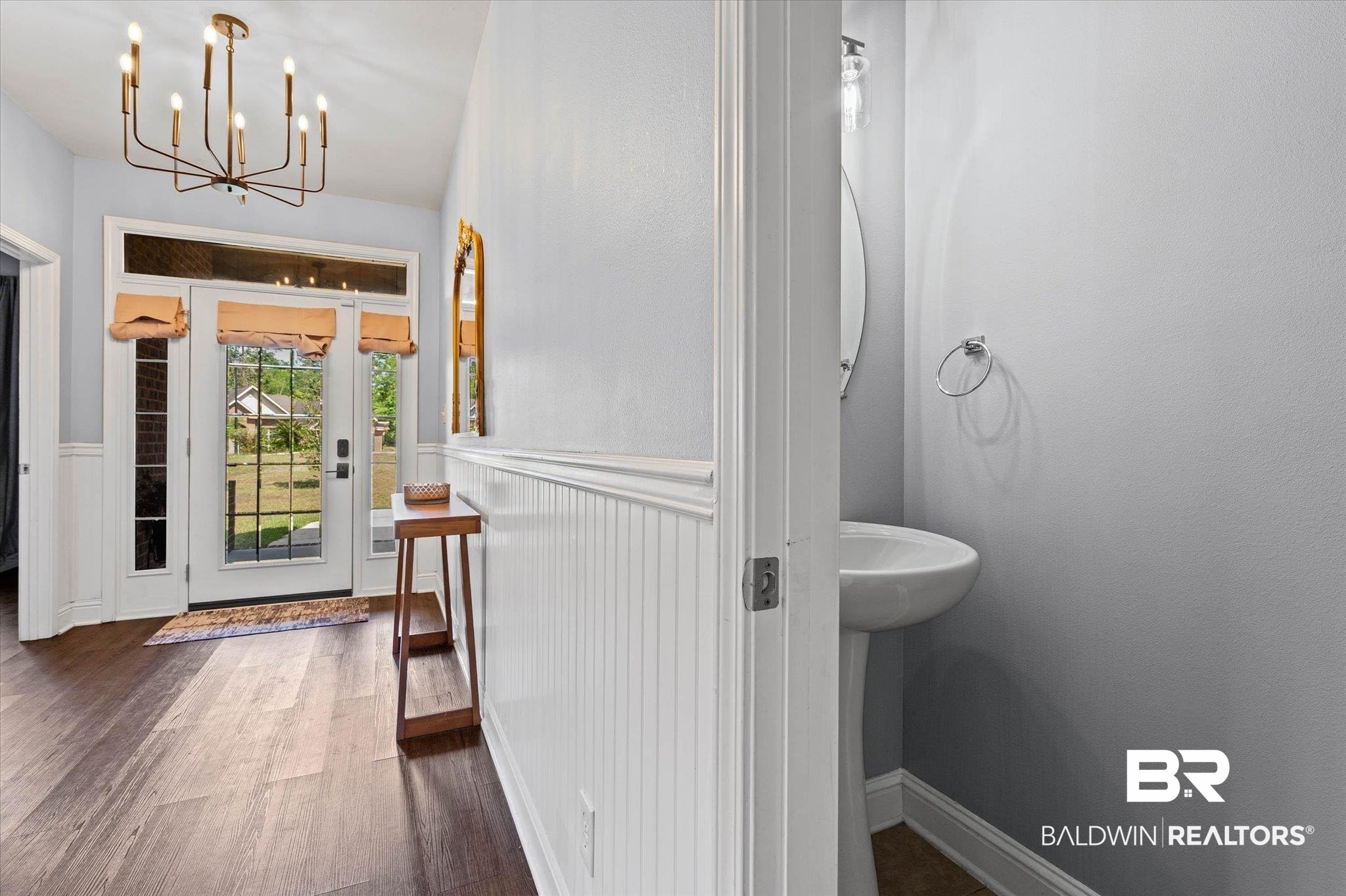 3739 Whitestone Drive Semmes, AL 36575 - Photo 2 of 25 Entryway featuring wood-finish flooring, a contemporary chandelier, and wainscoting details