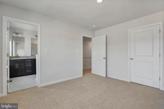 a view of an empty room and a bathroom