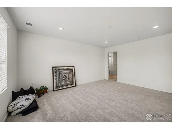 a hallway with a bed and couch