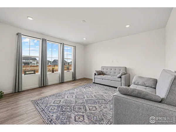 a living room with furniture and large windows