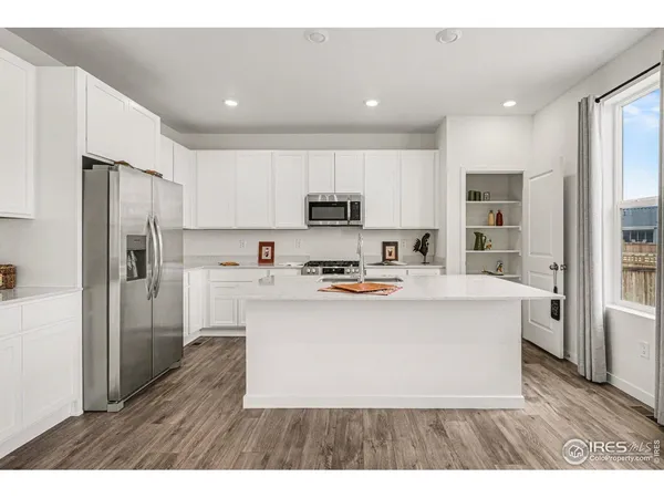 a kitchen with a sink stove and wooden cabinets