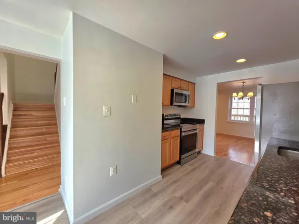 a kitchen with stainless steel appliances granite countertop a stove and a refrigerator
