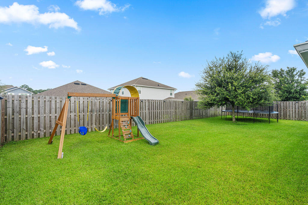 510 Earl Godwin Road Freeport, FL 32439 - Photo 31 of 42 a view of a backyard with a slide and a fire pit
