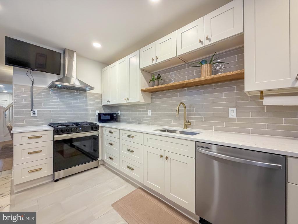 213 New Brook Street Bristol, PA 19007 - Photo 11 of 37 a kitchen with white cabinets and appliances