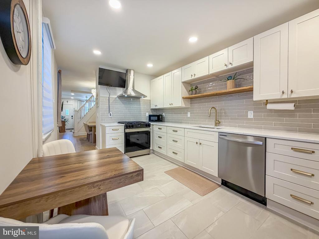 213 New Brook Street Bristol, PA 19007 - Photo 13 of 37 a kitchen with a sink stainless steel appliances and cabinets