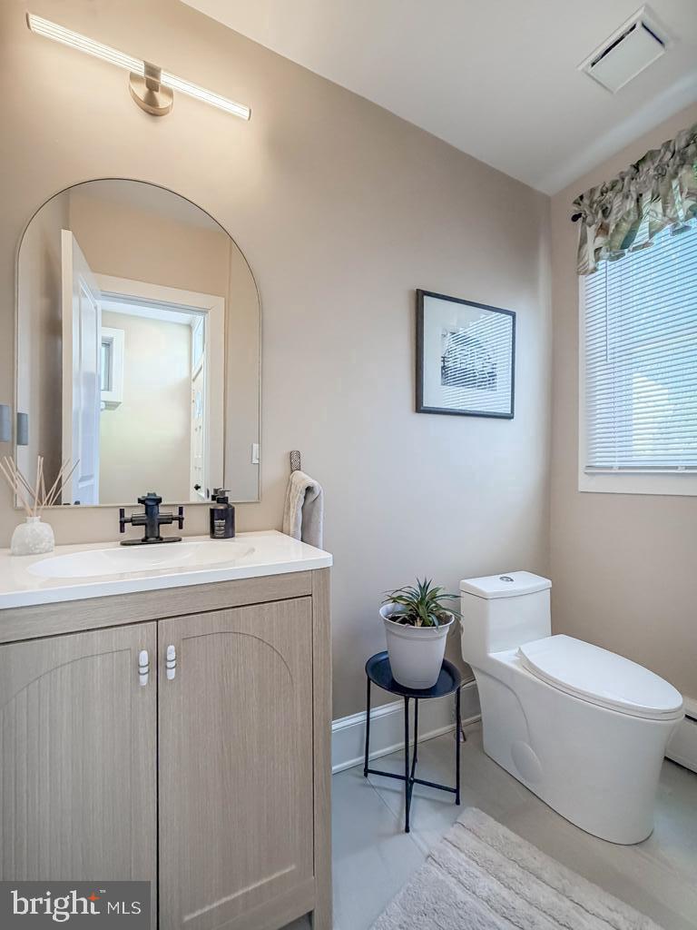 213 New Brook Street Bristol, PA 19007 - Photo 15 of 37 a spacious bathroom with a toilet a sink and a mirror