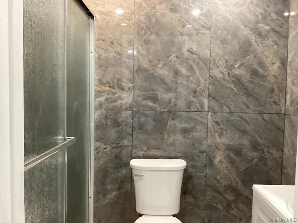 a bathroom with a toilet and a shower