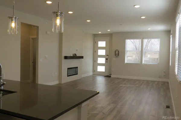 a kitchen with kitchen island white cabinetry and a wooden floor