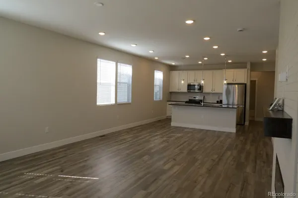 a view of kitchen with wooden floor and electronic appliances