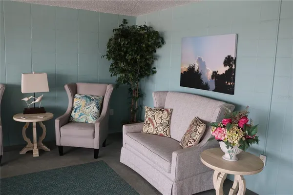 a living room with furniture and flowers