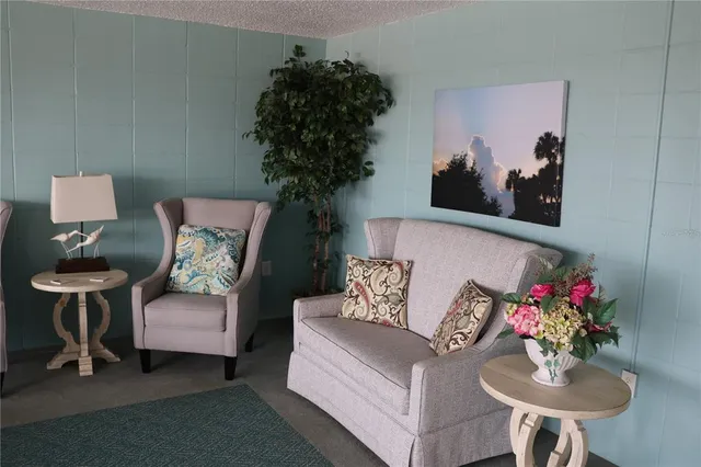 a living room with furniture and flowers