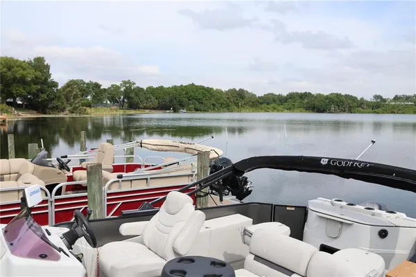 a view of a lake with couches and wooden floor