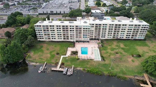 a view of a swimming pool with a lawn chairs under an umbrella