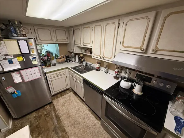 a kitchen with a sink appliances and cabinets