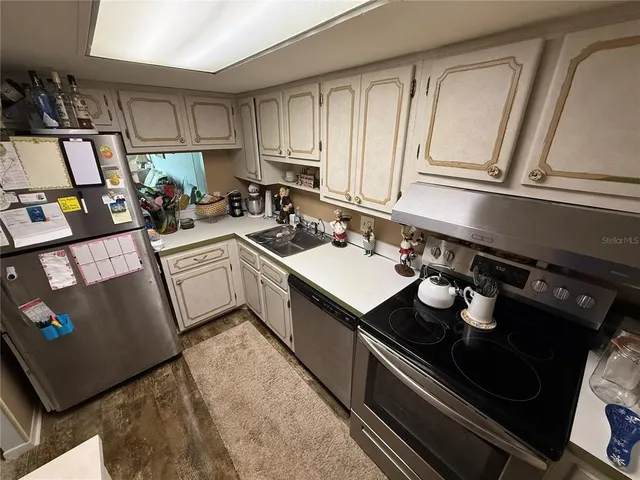 a kitchen with a sink appliances and cabinets
