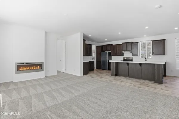 a large kitchen with kitchen island a sink stainless steel appliances and cabinets