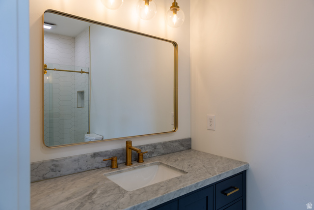 868 Braddock Lane Alpine, UT 84004 - Photo 29 of 64 Bathroom vanity featuring a gold-framed mirror and three-light fixture