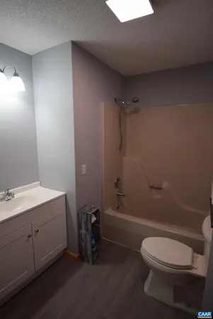 a bathroom with a toilet a sink and bathtub